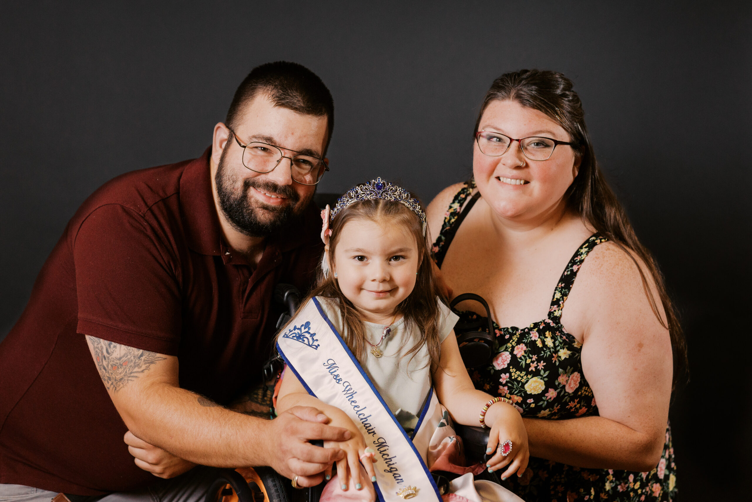 An image of Dahlia and her family after winning Miss Wheelchair Michigan