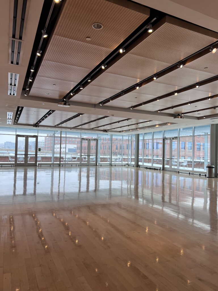 Empty Banquet Room with a level hardwood floor and floor-to-ceiling windows