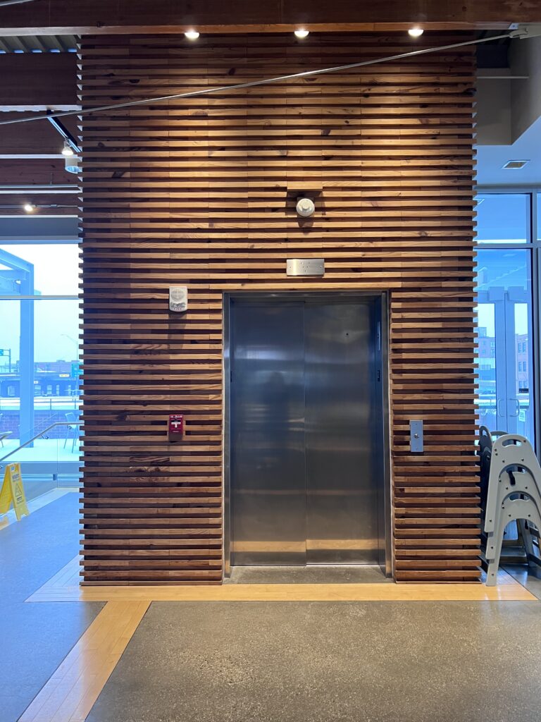 Elevator with a wood slat surround inside the Downtown Market