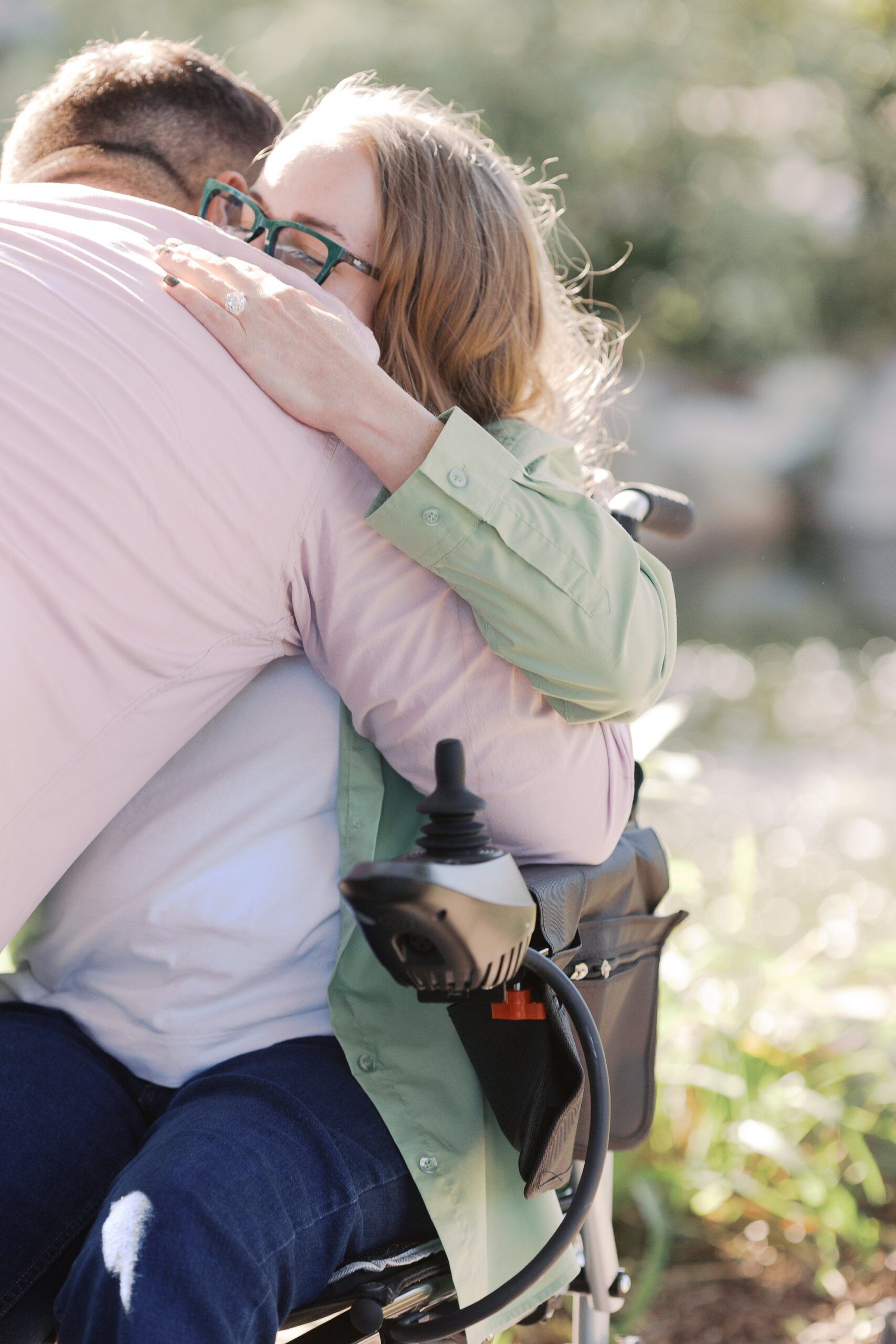 Katie hugging Saleem from her power wheelchair right after he proposed