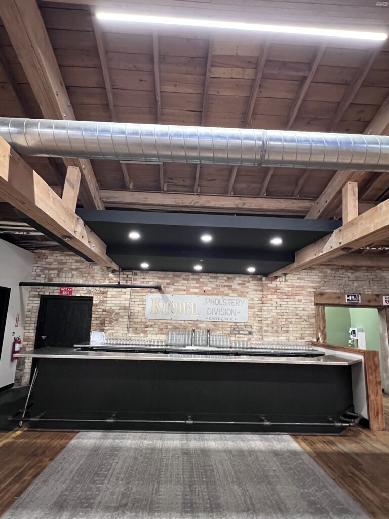 Bar with a brick wall and a rug in front of it