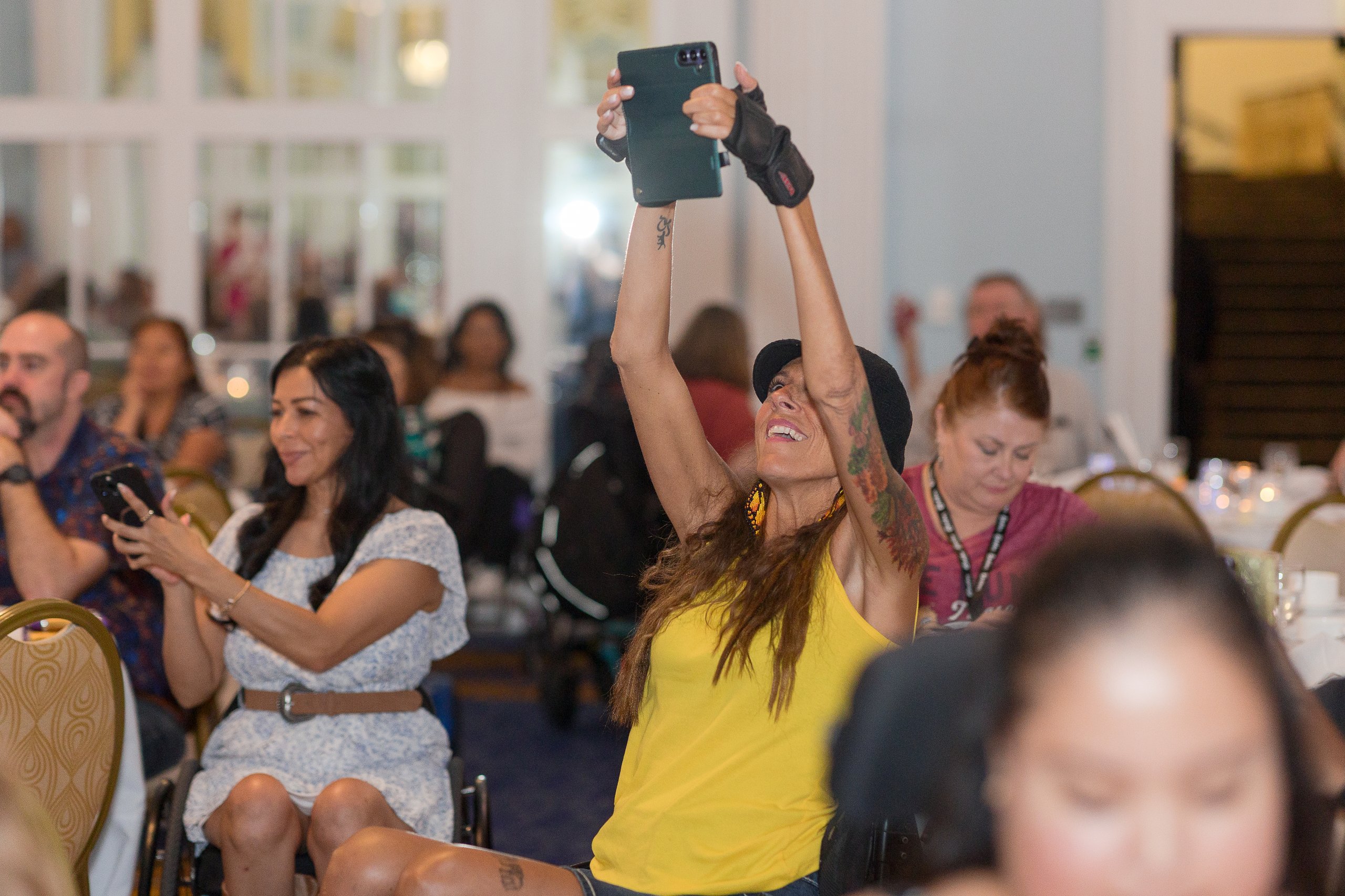 Guests cheering and taking photos during Re-Sashing Night at Ms. Wheelchair America 2027