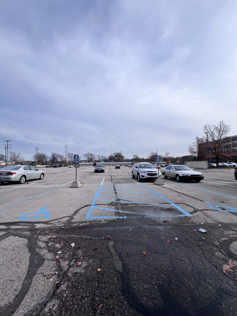Accessible parking spaces with blue-striped access aisles in the New Vintage Place parking lot.