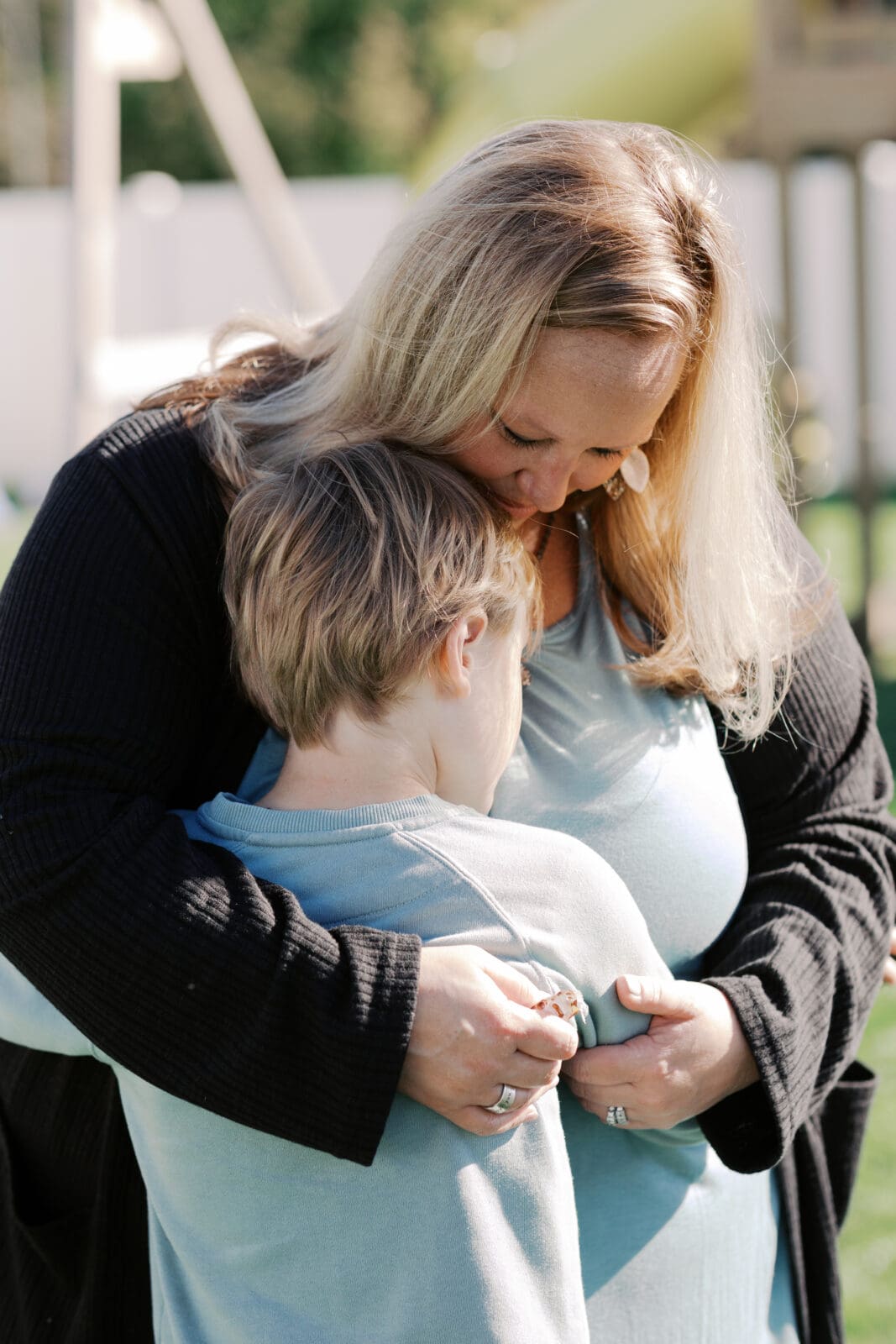 Candid family photo of parent and child with autism during a lifestyle photography session in Grand Rapids Michigan.